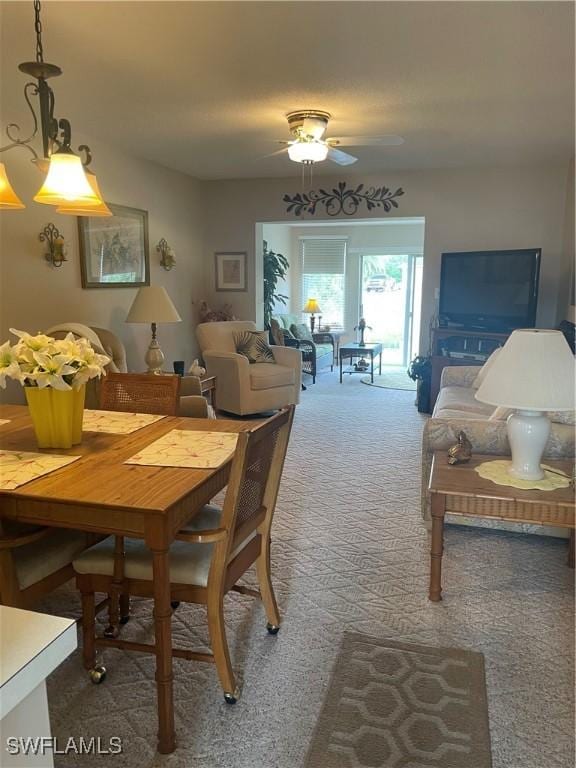 carpeted dining space with a ceiling fan