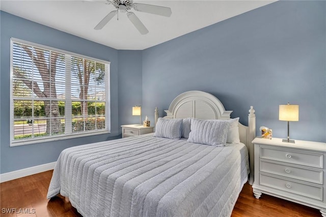 bedroom with ceiling fan, baseboards, and wood finished floors