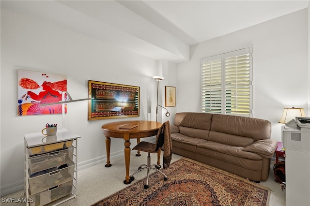 living area featuring baseboards