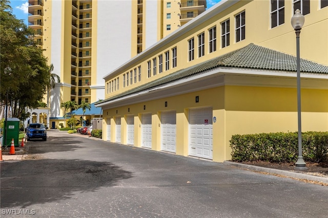 view of building exterior featuring community garages