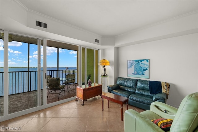 living room with ornamental molding, a water view, visible vents, and light tile patterned floors