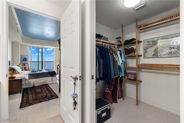 walk in closet with carpet floors and visible vents