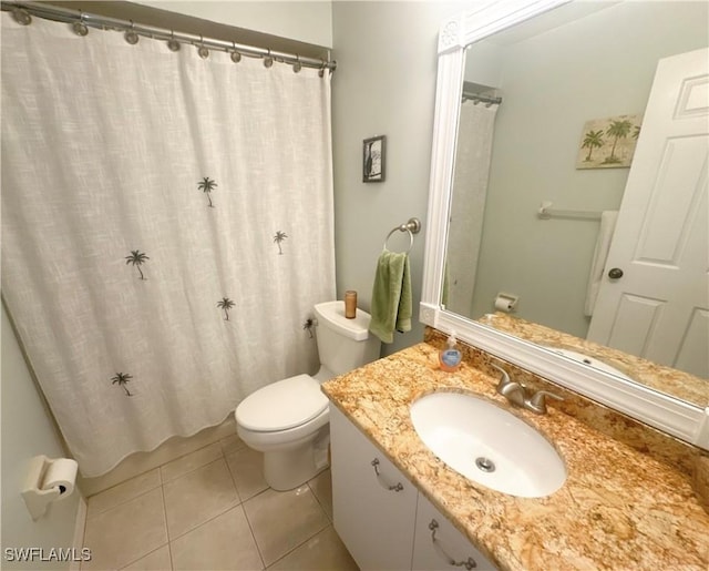 bathroom with vanity, toilet, and tile patterned floors