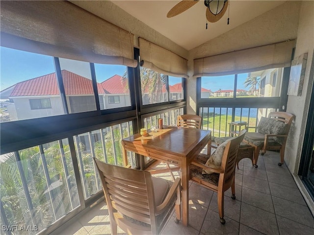 sunroom / solarium featuring a ceiling fan and vaulted ceiling