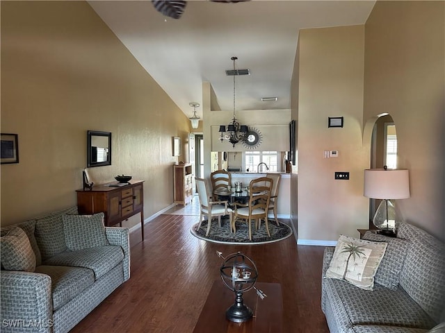 11570 Caravel Cir Unit 2022, Fort Myers, FL 33908 - living area with arched walkways, a chandelier, baseboards, wood finished floors, and a towering ceiling