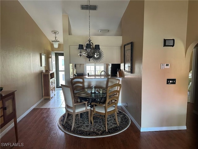 11570 Caravel Cir Unit 2022, Fort Myers, FL 33908 - dining space with arched walkways, wood finished floors, a chandelier, and baseboards