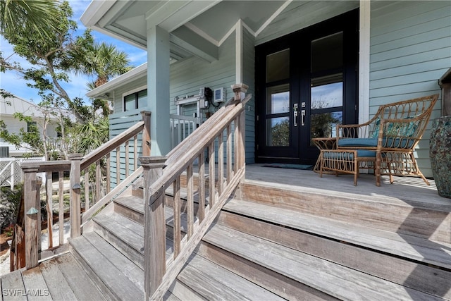 entrance to property with covered porch and french doors