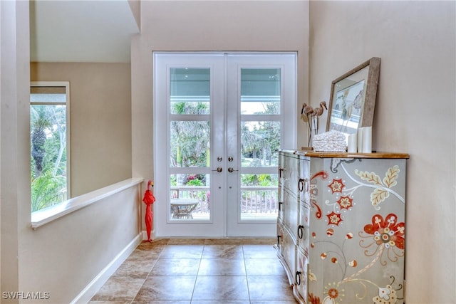 doorway featuring french doors and baseboards