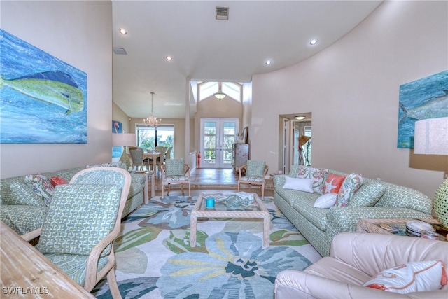 living room with high vaulted ceiling, french doors, visible vents, and recessed lighting