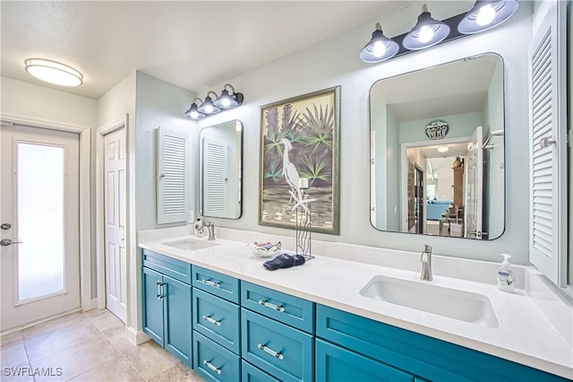 full bathroom featuring double vanity, a closet, a sink, and tile patterned floors