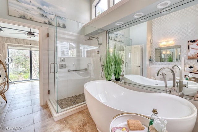 full bath with a stall shower, a soaking tub, tile patterned flooring, and a ceiling fan