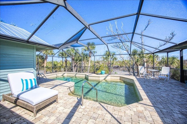 view of swimming pool with a fenced in pool, a lanai, and a patio area