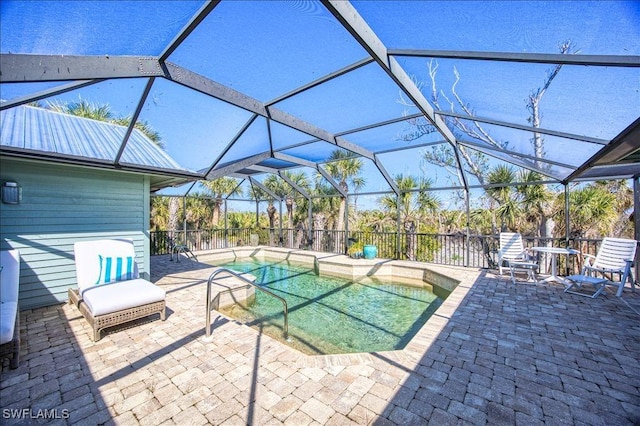 view of swimming pool featuring glass enclosure and a patio