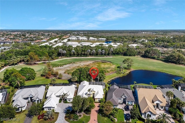 aerial view featuring golf course view, a water view, and a residential view