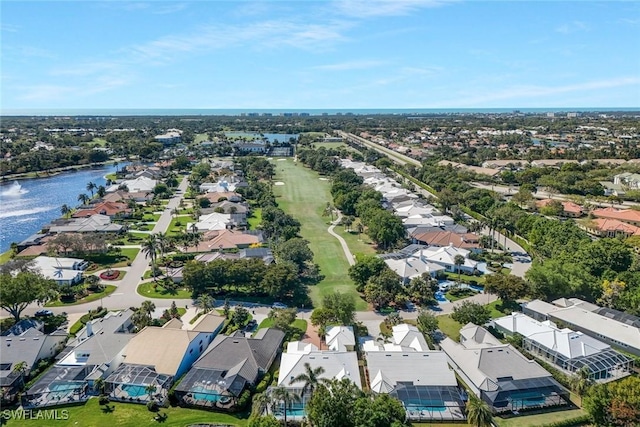 drone / aerial view featuring a residential view and a water view