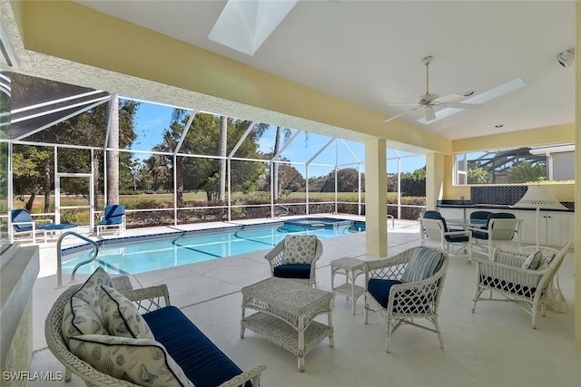 view of swimming pool featuring a ceiling fan, a lanai, a patio area, and a pool with connected hot tub