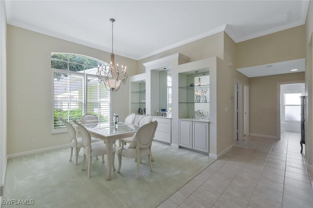 dining area featuring light tile patterned floors, built in shelves, baseboards, crown molding, and a chandelier