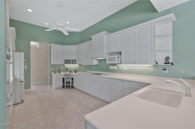 kitchen with a sink, light countertops, white appliances, white cabinetry, and open shelves