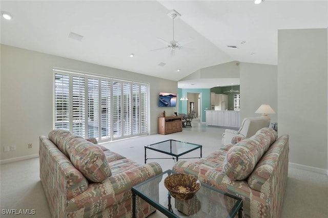 living room with light colored carpet, ceiling fan, baseboards, and vaulted ceiling