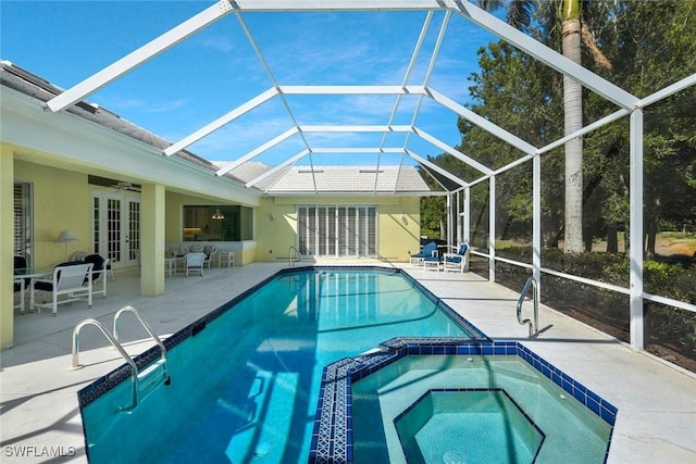 view of pool with a pool with connected hot tub, french doors, glass enclosure, ceiling fan, and a patio area