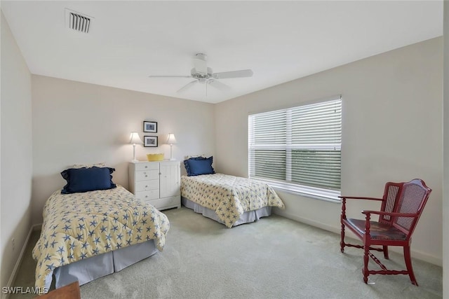 bedroom with baseboards, visible vents, carpet floors, and ceiling fan