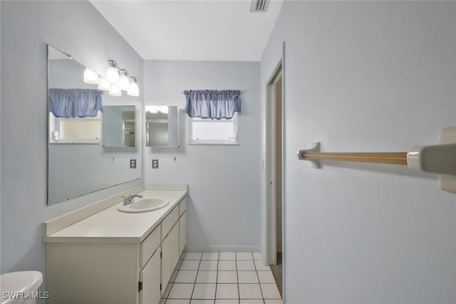 full bath featuring visible vents, toilet, vanity, baseboards, and tile patterned floors