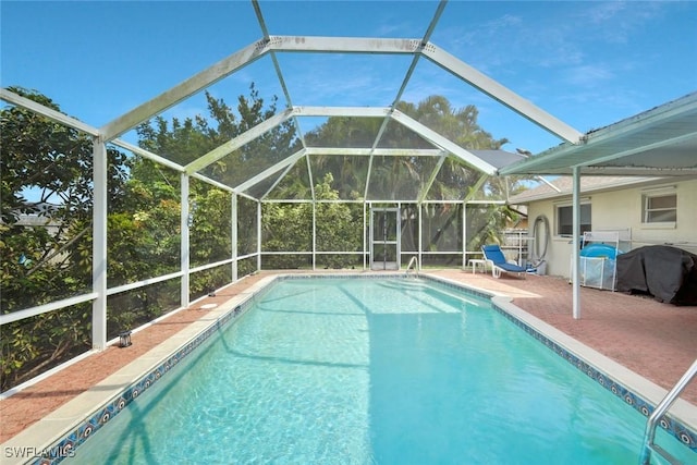 pool featuring glass enclosure, a grill, and a patio