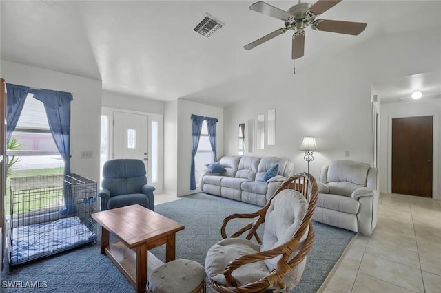 living area with ceiling fan, visible vents, and light tile patterned flooring