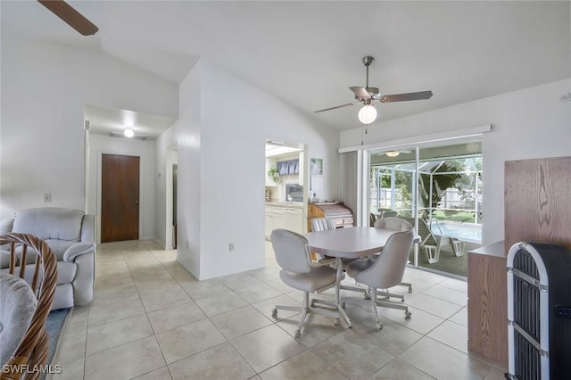 dining area with heating unit, lofted ceiling, a sunroom, light tile patterned flooring, and ceiling fan