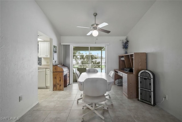 dining space featuring lofted ceiling, ceiling fan, and light tile patterned flooring