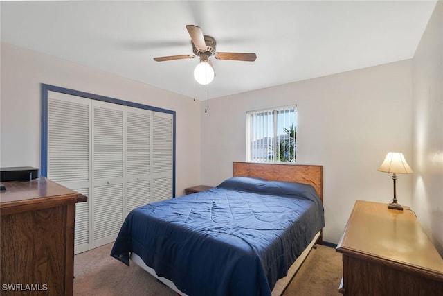 carpeted bedroom featuring ceiling fan and a closet