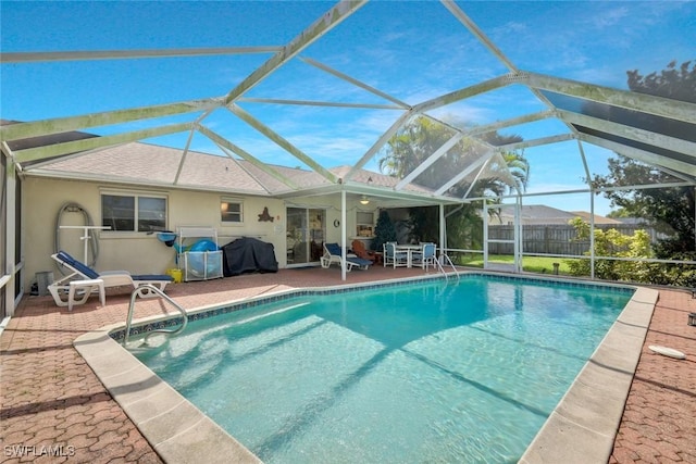 outdoor pool with a lanai, a patio, area for grilling, and fence