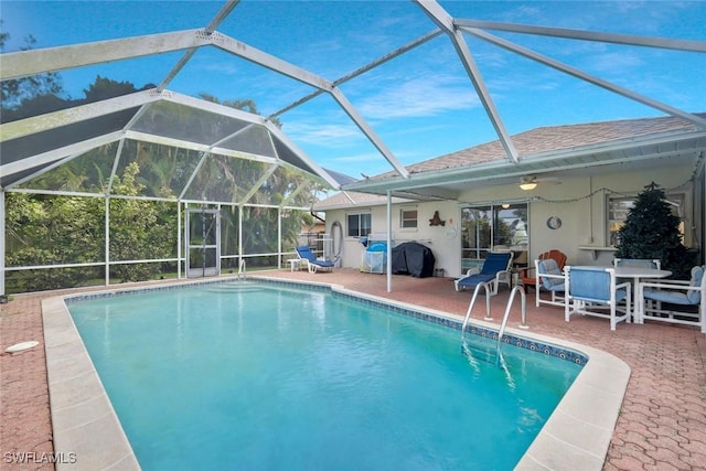 outdoor pool featuring a ceiling fan, area for grilling, a lanai, outdoor dining area, and a patio area