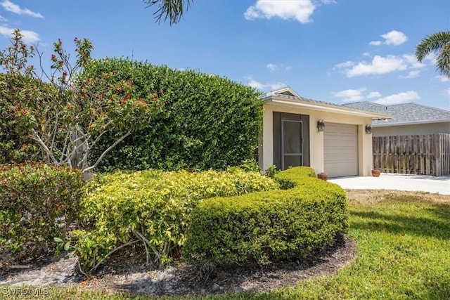 569 98th Ave N, Naples, FL 34108 - view of outdoor structure featuring a garage and concrete driveway