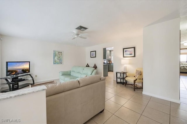569 98th Ave N, Naples, FL 34108 - living room featuring light tile patterned flooring, a ceiling fan, and baseboards