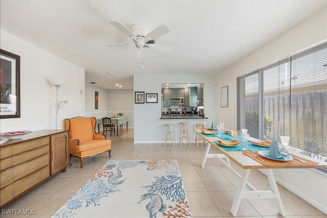 569 98th Ave N, Naples, FL 34108 - dining space with light tile patterned floors, ceiling fan, and baseboards