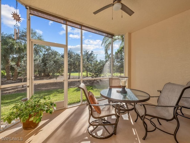 sunroom featuring a ceiling fan