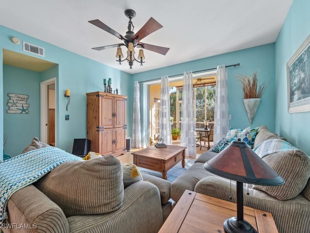 interior space with access to outside, wood finished floors, visible vents, and a ceiling fan