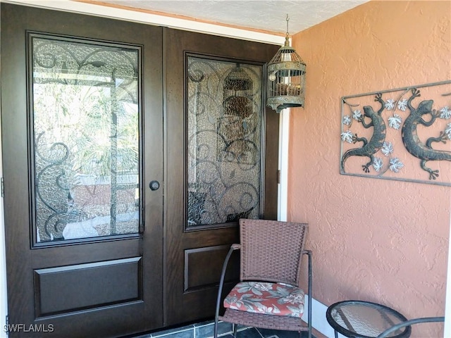 entrance to property with stucco siding and french doors