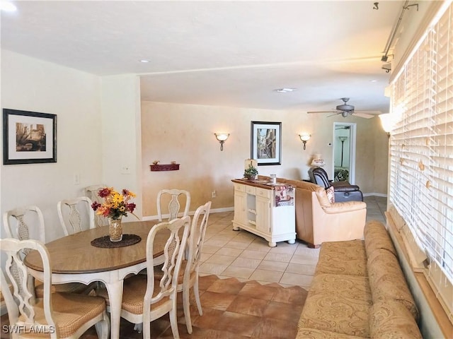 dining space featuring light tile patterned floors, ceiling fan, and rail lighting