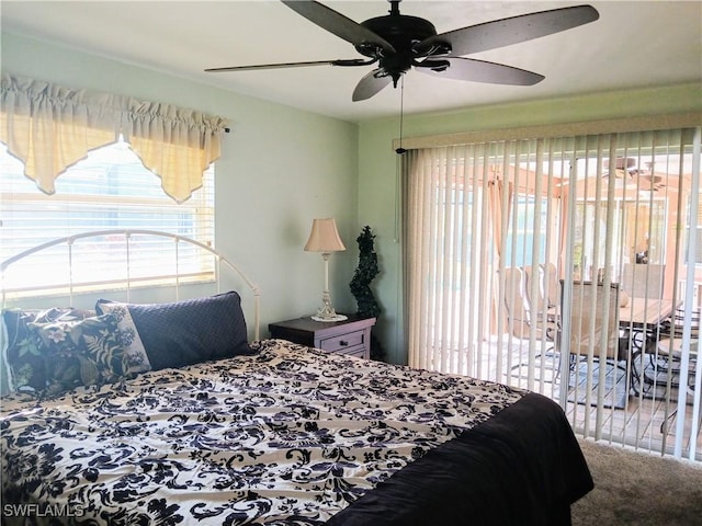 bedroom with access to exterior, carpet, and a ceiling fan