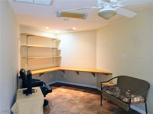 office space featuring recessed lighting, ceiling fan, built in desk, and baseboards