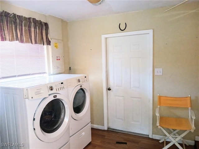 washroom with laundry area, dark wood finished floors, baseboards, and separate washer and dryer