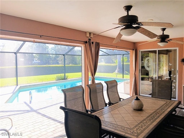 sunroom featuring ceiling fan