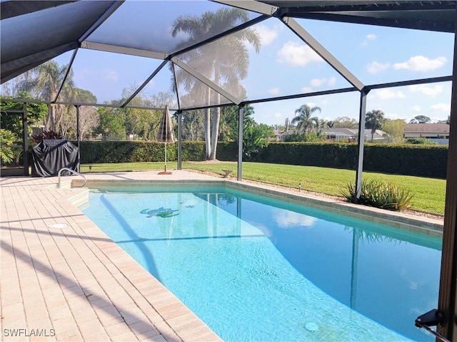 pool with a yard and a patio