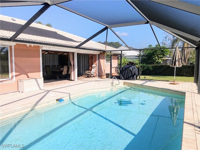 pool featuring a patio area, glass enclosure, and a ceiling fan