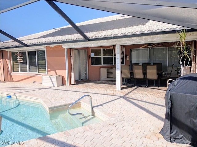 outdoor pool with a lanai and a patio