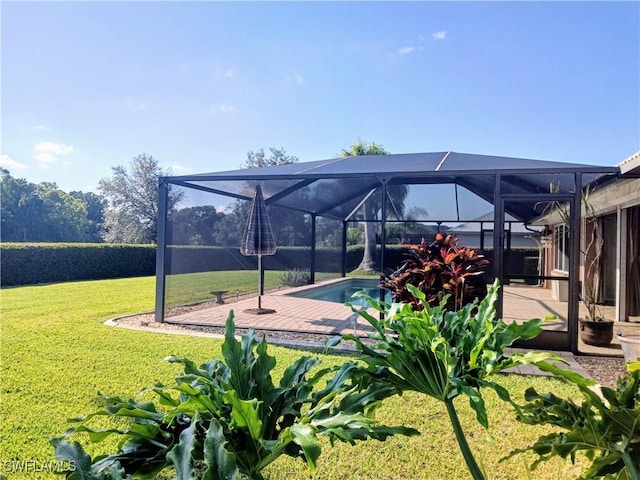 view of property's community with a swimming pool, a lawn, and a patio