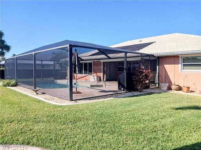 back of house with an outdoor pool, a lawn, a patio, glass enclosure, and stucco siding