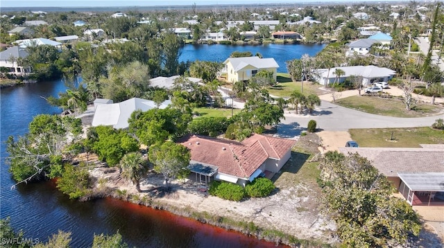 bird's eye view featuring a water view and a residential view